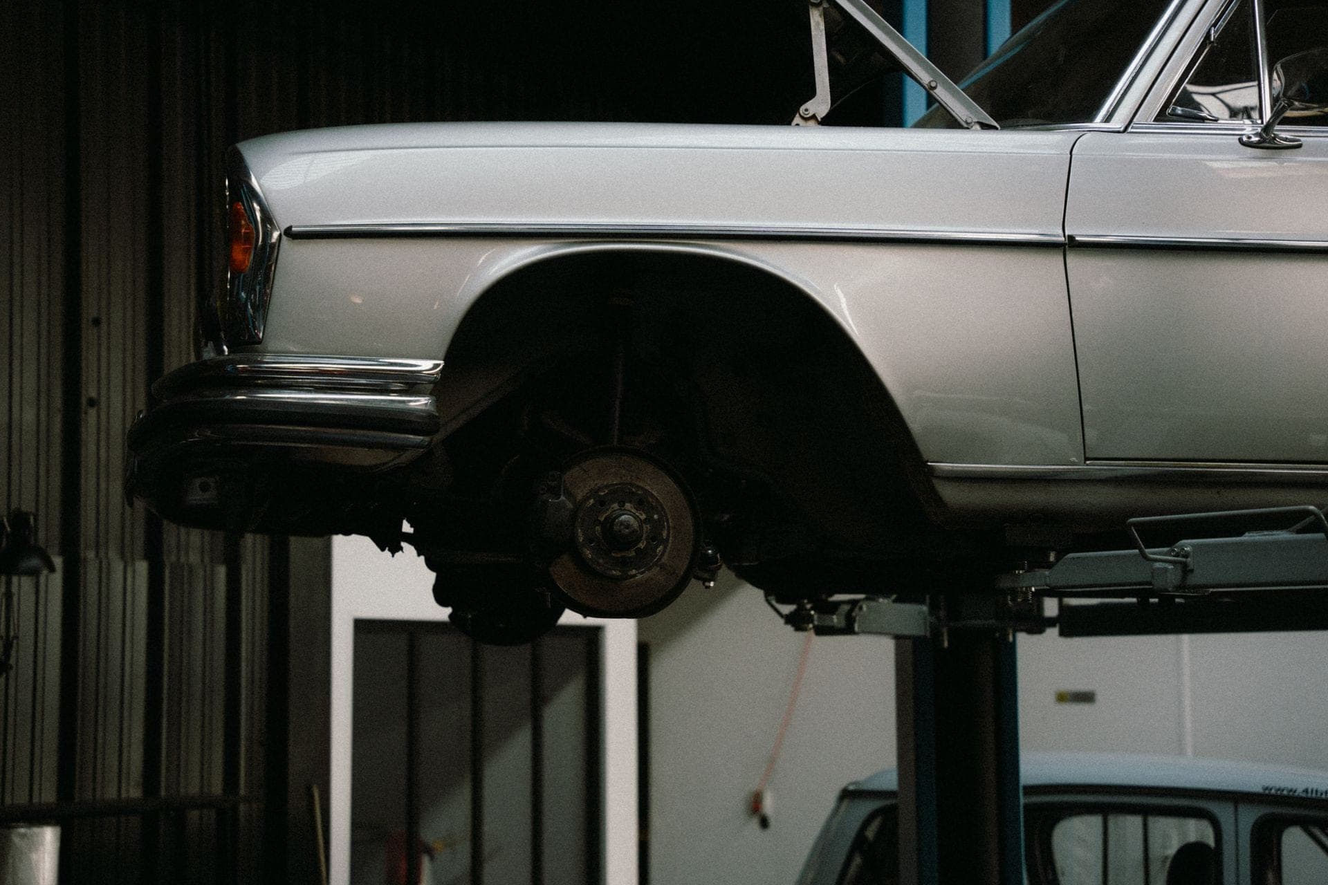 A car on the lift inside the Switchyard Motor Works shop, lit low after hours
